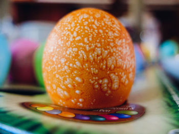 Close-up of orange dyed easter egg on table