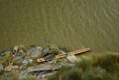High angle view of wooden rafts moored at riverbank