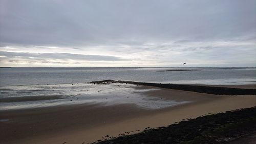 View of calm beach against the sky