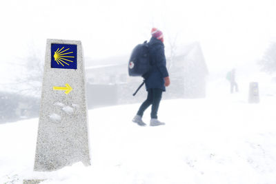 Full length of man walking in snow