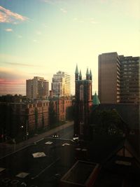 Buildings in city at sunset