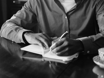 Midsection of man working at table