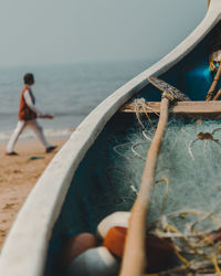 Close-up of oar and fishing net in boat