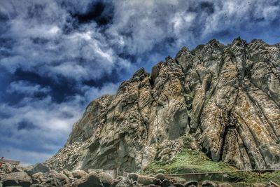 Low angle view of rock formation against sky