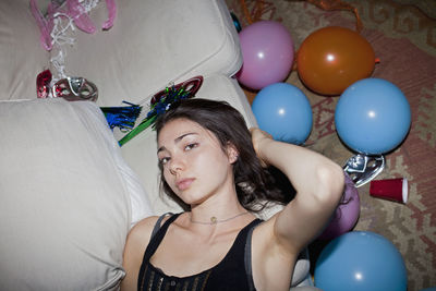 Portrait of young woman with balloons