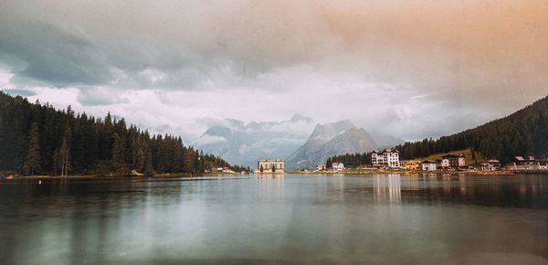 Scenic view of lake misurina against cloudy sky during sunset