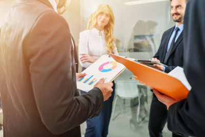 Midsection of business colleagues working at office