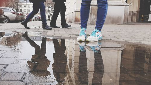 Low section of people standing on street