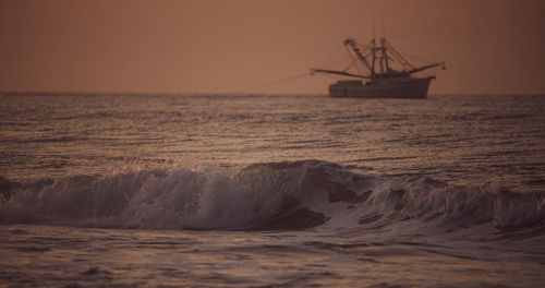 Scenic view of sea against clear sky during sunset