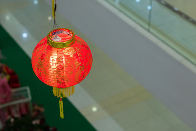 Illuminated lantern hanging indoors