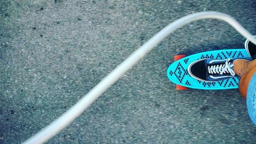 Low section of person skateboarding on road