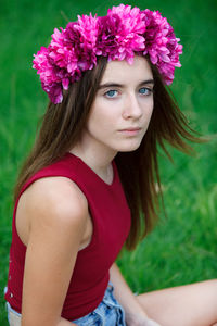 Portrait of beautiful woman with red flower