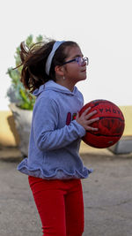 Young woman playing basketball