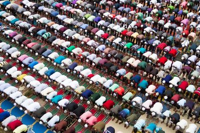 High angle view of men praying in mosque