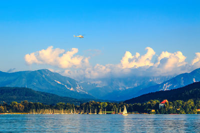 Scenic view of lake and mountains against sky