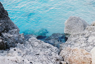 High angle view of rocks by sea