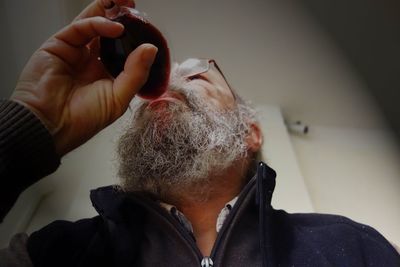 Close-up of mature man drinking red wine