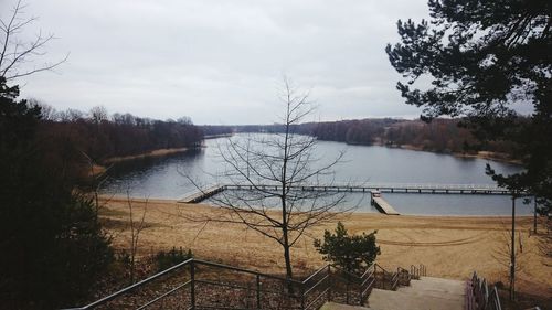 Calm lake with trees in background