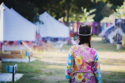 Rear view of woman standing on field