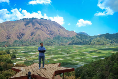 Full length of man standing on observation point against mountain 