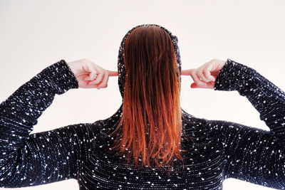 Midsection of woman wearing hat against white background