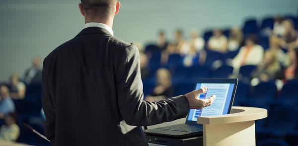 Midsection of businessman using laptop