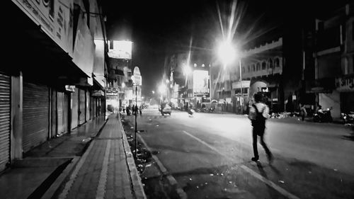 Illuminated city street at night