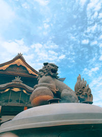 Low angle view of statue against sky