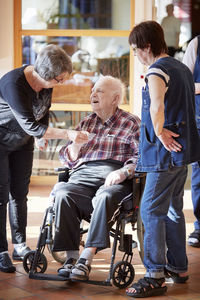 Nurses with smiling senior man in care home