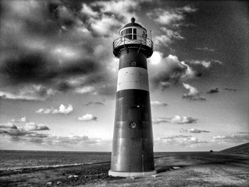 Lighthouse against cloudy sky