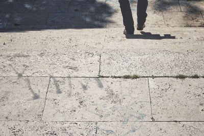 Low section of person standing on tiled floor