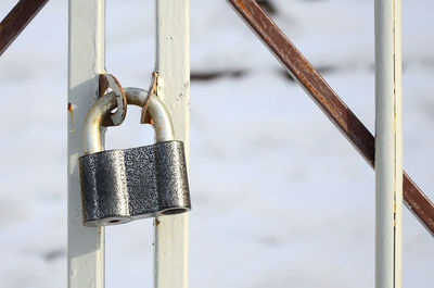 Close-up of padlock on metal railing