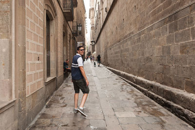 Full length of man walking in alley