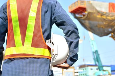 Midsection of man standing in city