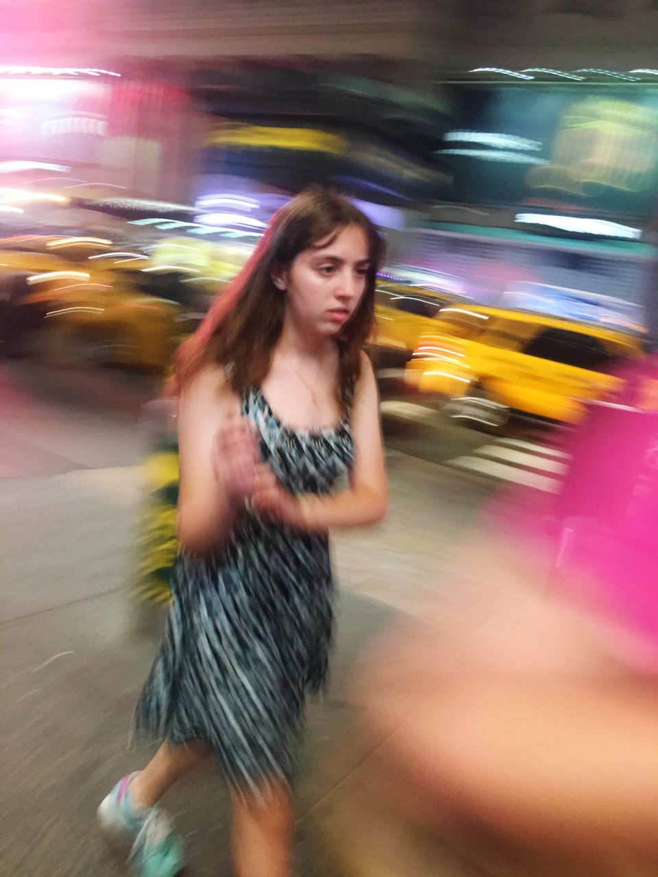 blurred motion, motion, one person, casual clothing, speed, lifestyles, three quarter length, road, night, real people, transportation, long hair, hairstyle, young women, women, young adult, street, city, leisure activity, nightlife, beautiful woman