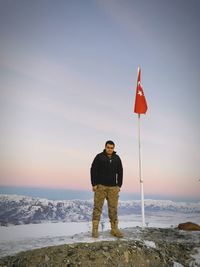 Full length of man standing on snow covered land