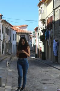 Woman sitting in front of buildings