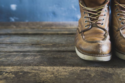 Close-up of shoes on wooden table