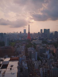 View of cityscape against cloudy sky