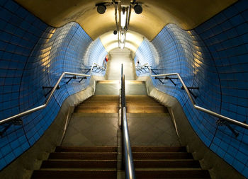 Low angle view of illuminated underground walkway