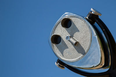 Low angle view of camera against blue sky