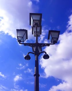 Low angle view of street light against cloudy sky