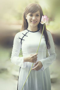 Portrait of smiling woman standing outdoors