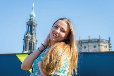 A young beautiful girl walks around the city on excursions.