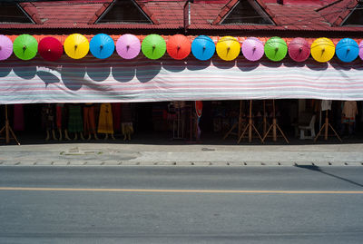 Multi colored umbrellas hanging on street in city