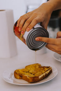 Close-up of person preparing  french toast 
