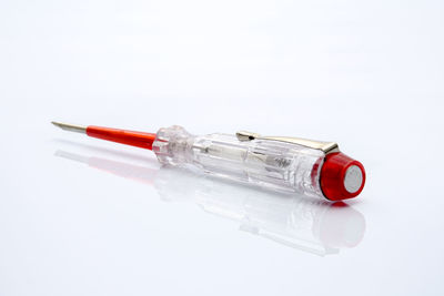 Close-up of screwdriver over white background