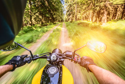 Blurred motion of person riding bicycle on road