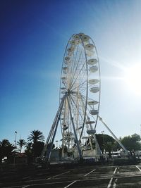 Low angle view of ferris wheel against clear sky