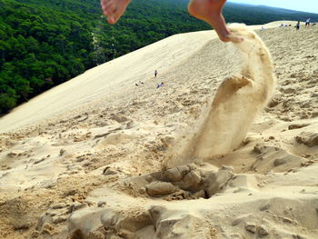 Midsection of people at beach